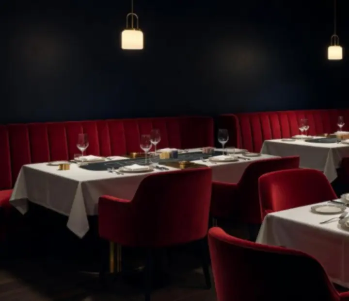 Midnight Obsidian dining room with velvet banquettes and brass-detailed poker tables